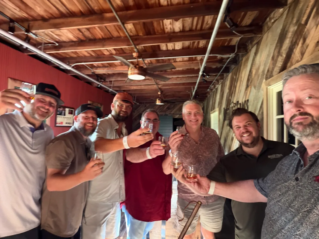 The group raising tasting glasses together in a Buffalo Trace barrel room.