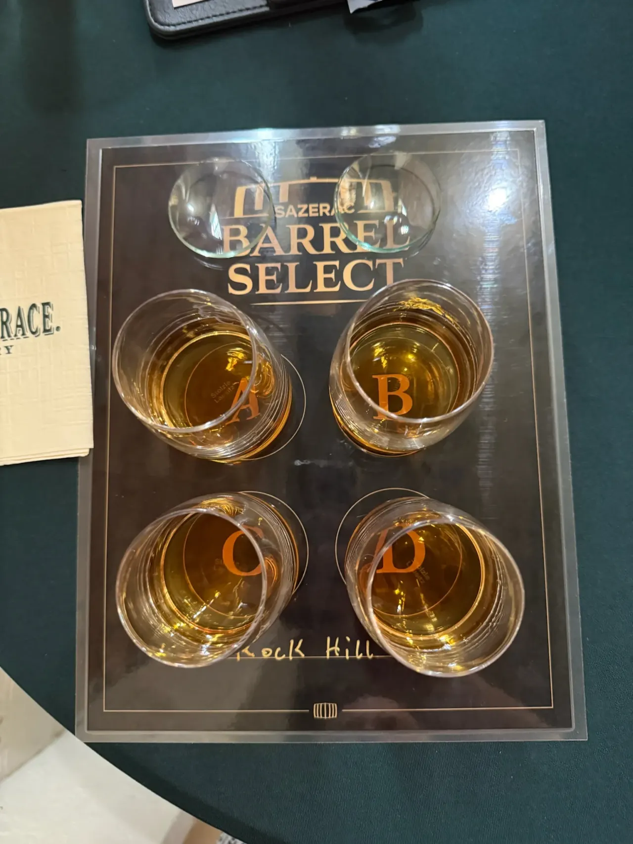 Four whiskey samples arranged for a comparative barrel tasting.