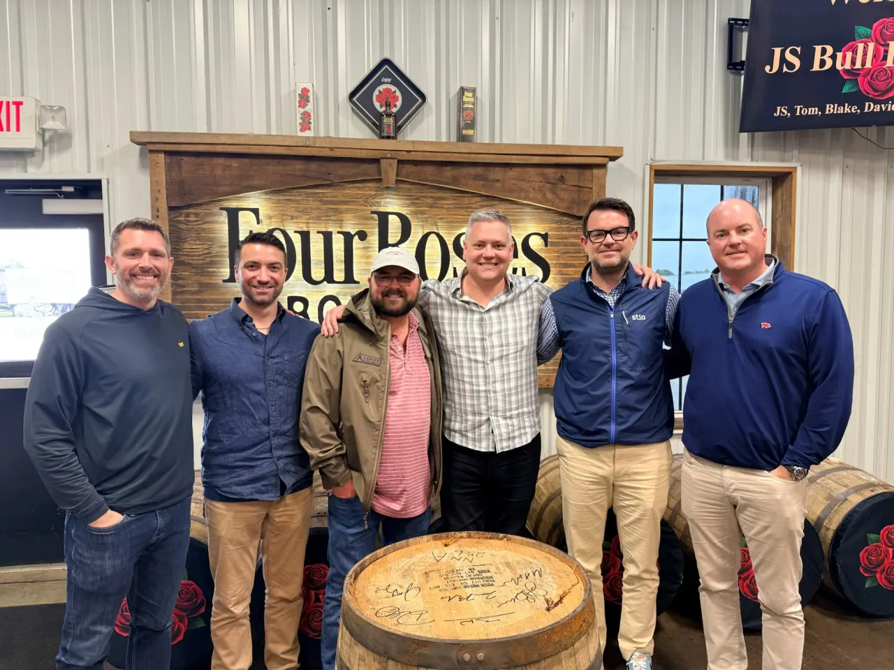 Members gathered behind their selected Four Roses barrel.