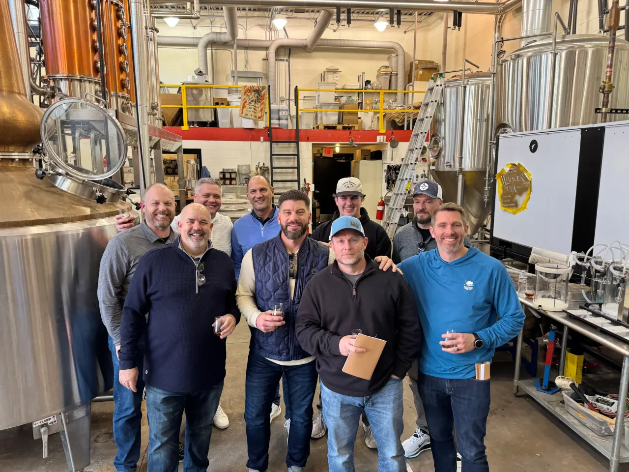The group beside copper and steel distilling equipment at Same Old Moses.