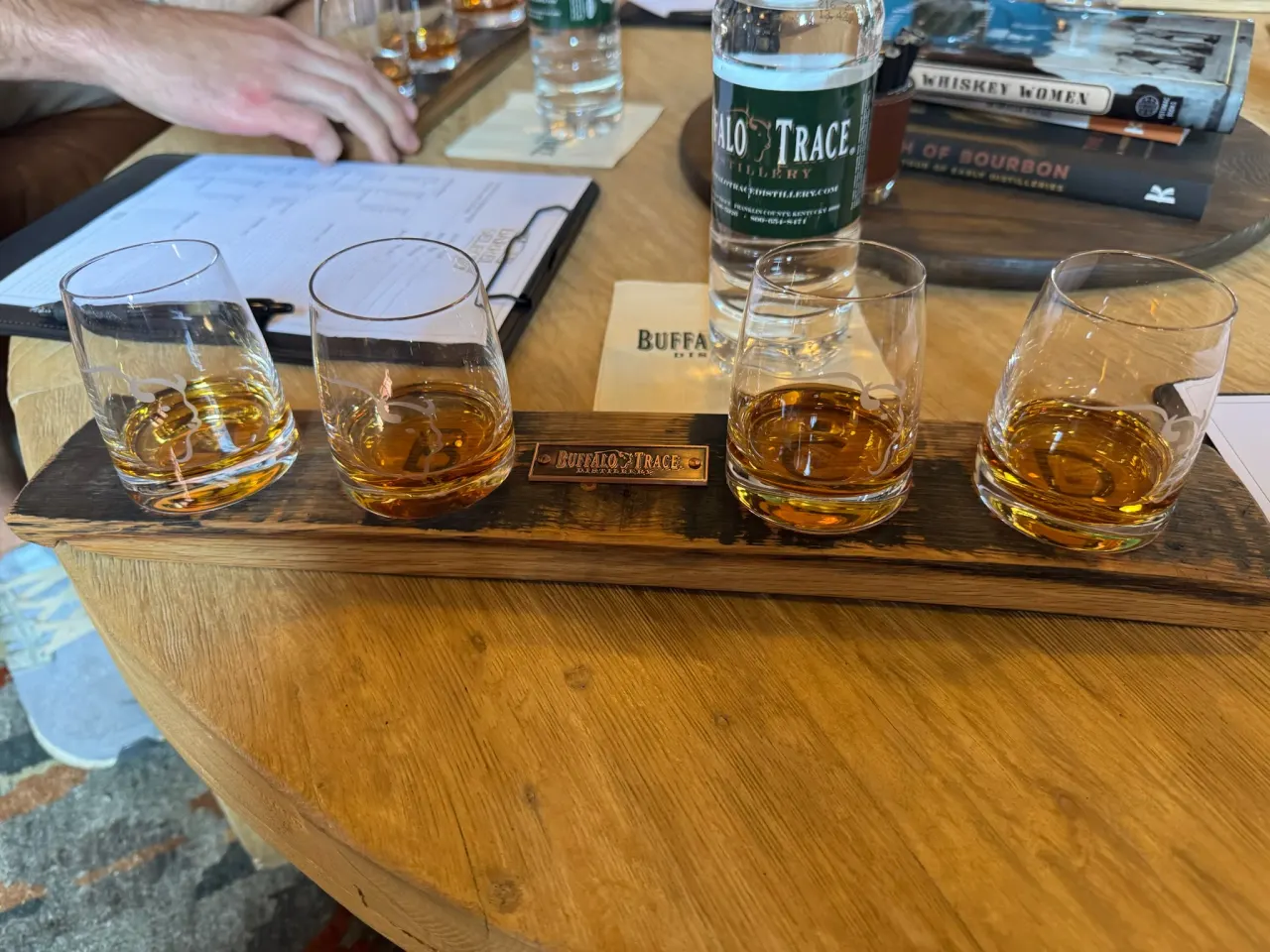 Whiskey samples on a wooden tasting table during a Buffalo Trace visit.